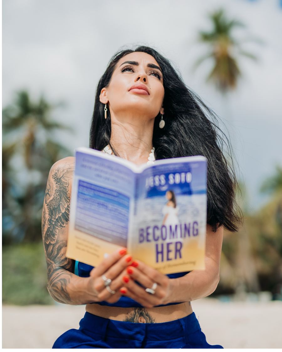 Jess Soto holding a copy of her memoir Becoming HER: A Journey of Remembering